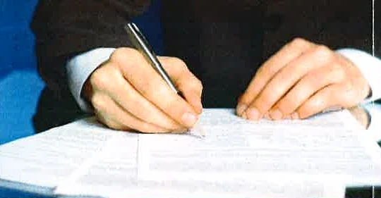 Hands signing claim documents